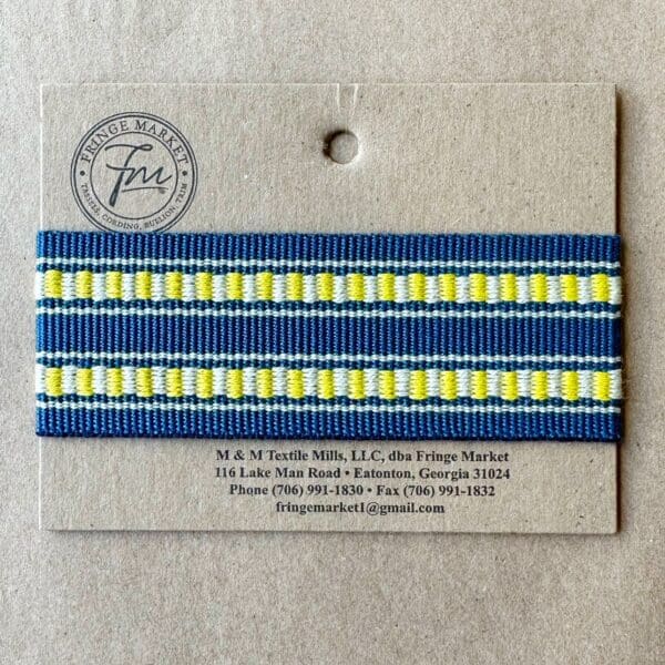 A blue and yellow striped ribbon on a card adorned with Solar Outdoor Tapes.