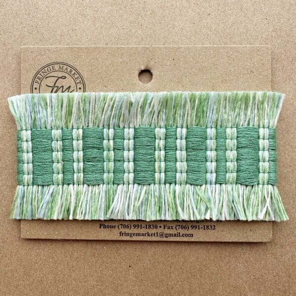 A green and white Fresco Outdoor Fringed Tapes on a piece of cardboard.