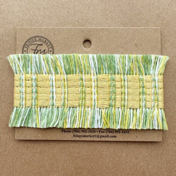 A green and white Fresco Outdoor Fringed Tapes woven trim on a card.