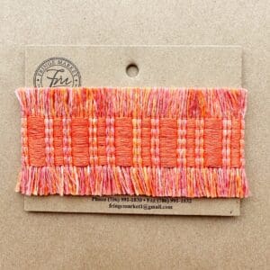 A piece of Fresco Outdoor Fringed Tapes with orange and pink fringes.