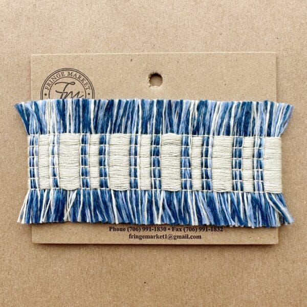 A Fresco Outdoor Fringed Tapes with a blue and white fringe on it.