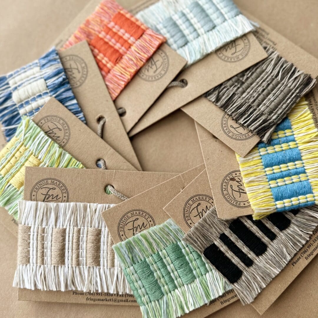 A group of Fresco Outdoor Fringed Tapes arranged on a piece of paper.