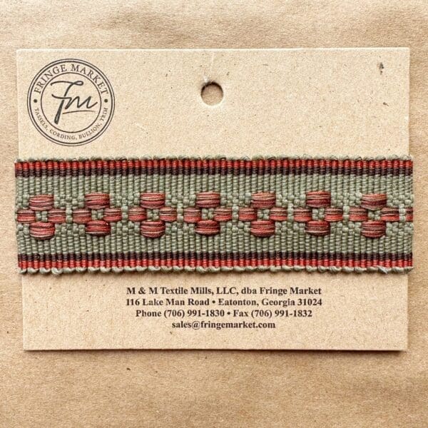 A Bowery Braids 1 3/8 in label with a red and green ribbon on it.