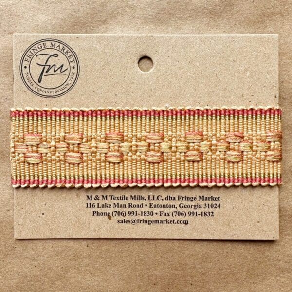 A label with a Bowery Braids 1 3/8 in gold and red ribbon on it.