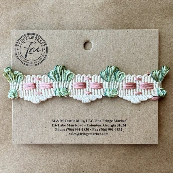 A green and pink braided ribbon on a card.