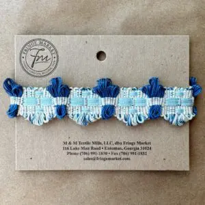 A blue and white Brooklyn Braids ribbon on a card.
