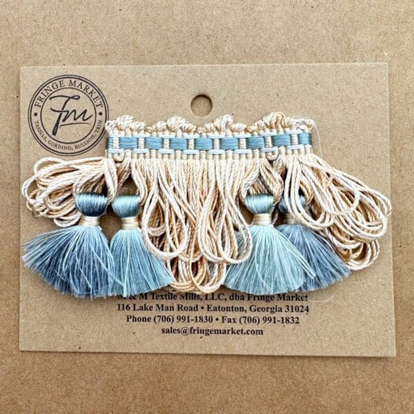 Yorkville Silk Tassel Fringe with blue and white beads on a card.