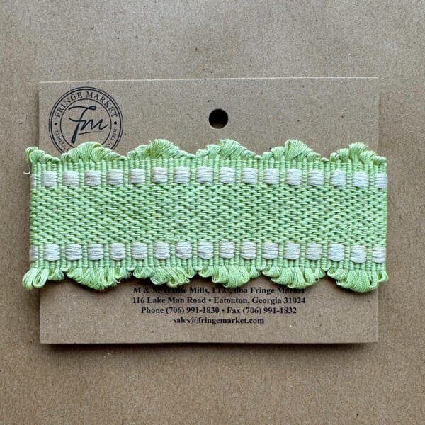 A green ribbon with white ruffles on Chelsea Silk Braids.