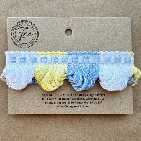 A card with blue and yellow Lenox Loop Fringe tassels.