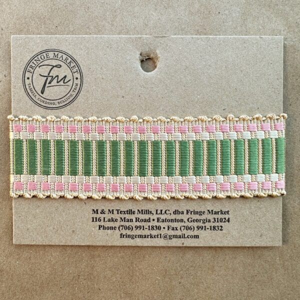 A green and pink Amity Silk Braids woven ribbon on a card.