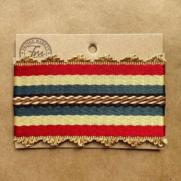 A red, yellow and blue striped Gramercy Silk Braids on a piece of paper.