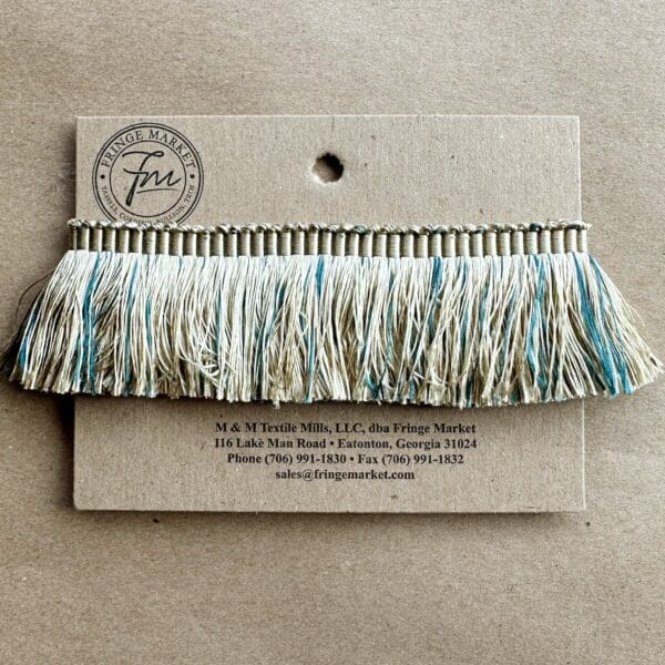 A card with a blue and white tassel on it.