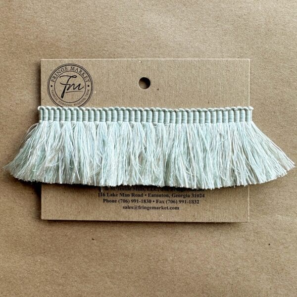 A card with a Silk 100% Cut Brush Fringe 1.5in trim on it.