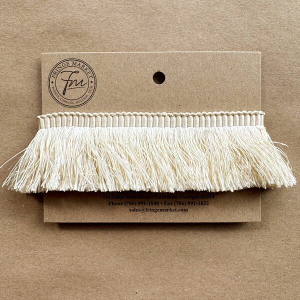 A Silk 100% Cut Brush Fringe 1.5in with a white fringe on it.