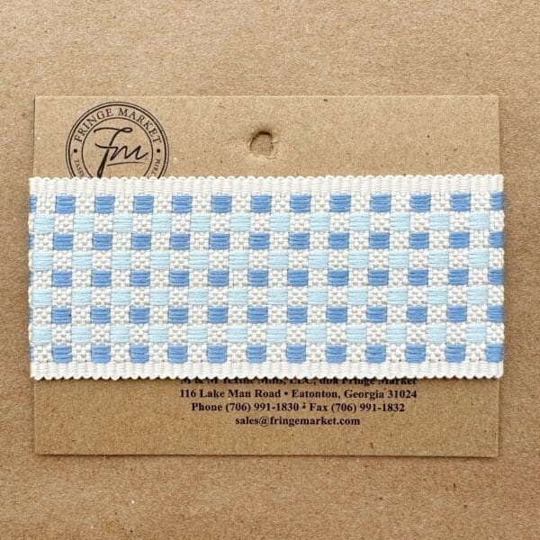 A Tabby Braid 2in sample attached to a cardboard label with printed contact information for Fringe Market.