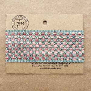 A Tabby Braid 2in sample card featuring a striped blue and pink fabric swatch, attached to a cardboard display with contact information printed above.
