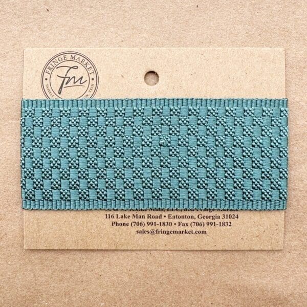 Rectangular business card with Tabby Braid 2in pattern design and contact details on a textured beige background.