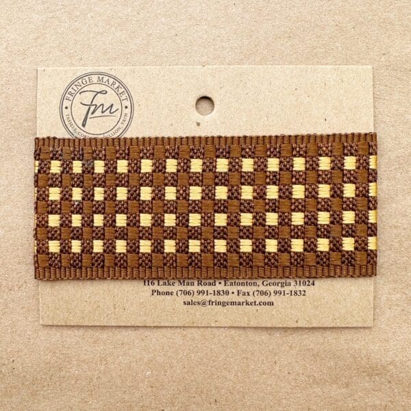 A business card for Tringe Market, displaying a decorative Tabby Braid 2in woven border, contact information, and company logo on a beige background.