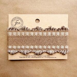 Beige woven fringe trim sample on card
