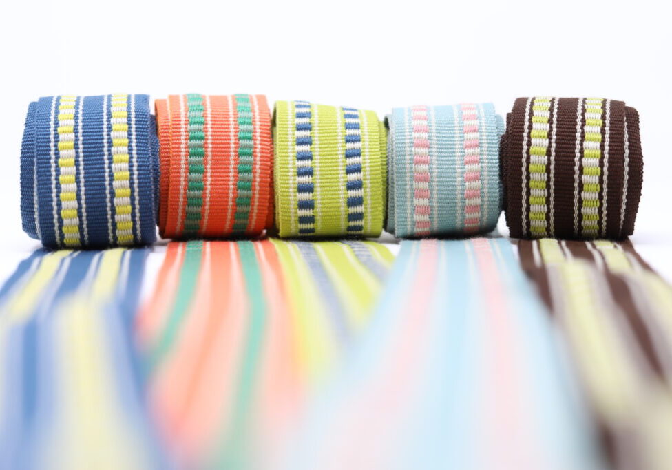 A row of colorful striped ribbons on a white background.